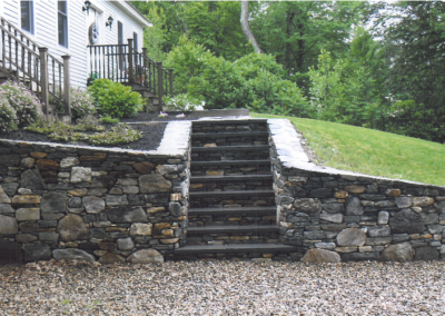 photo of stone retaining wall and stairs by Stone Builders Masonry