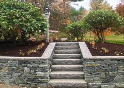 granite stairs and a natural stone retaining wall in Sterling MA